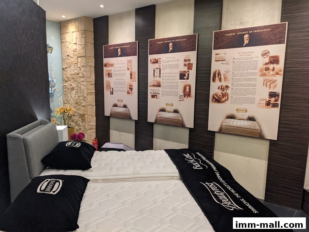 Interior view of a Simmons Gallery shop showcasing mattresses and historical innovation displays.