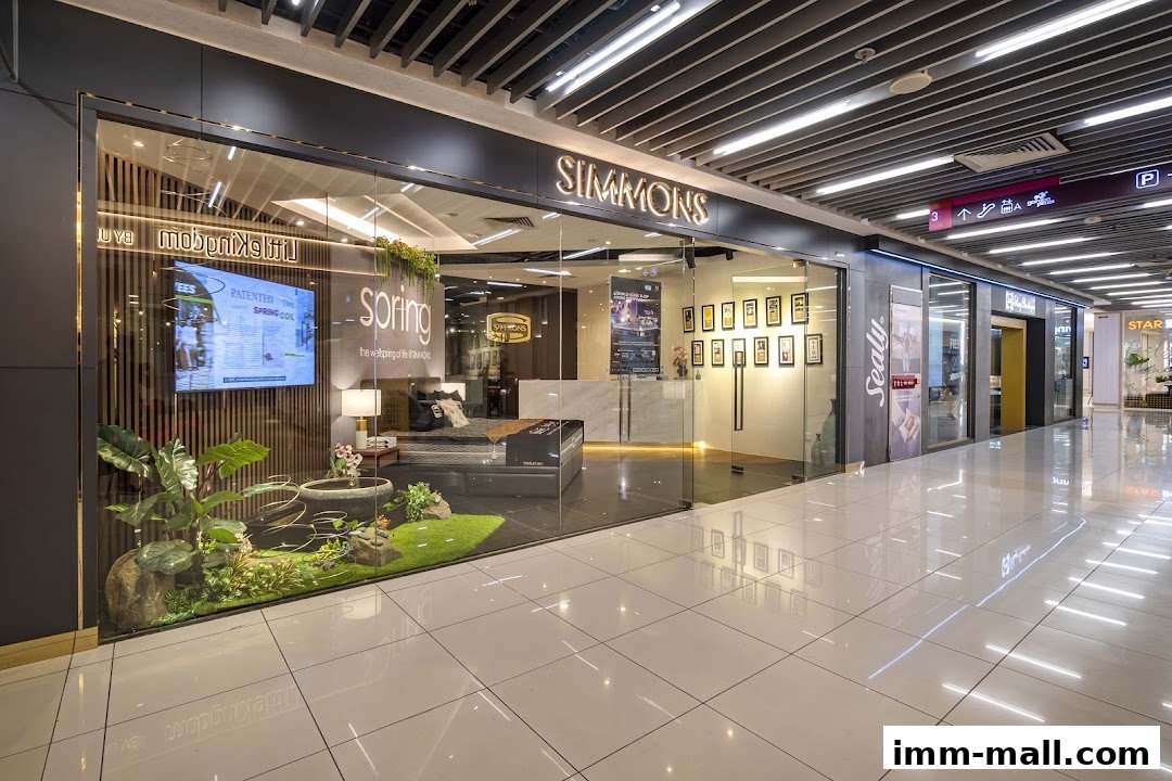 The Simmons Gallery shop front displays a mattress and a decorative garden area.