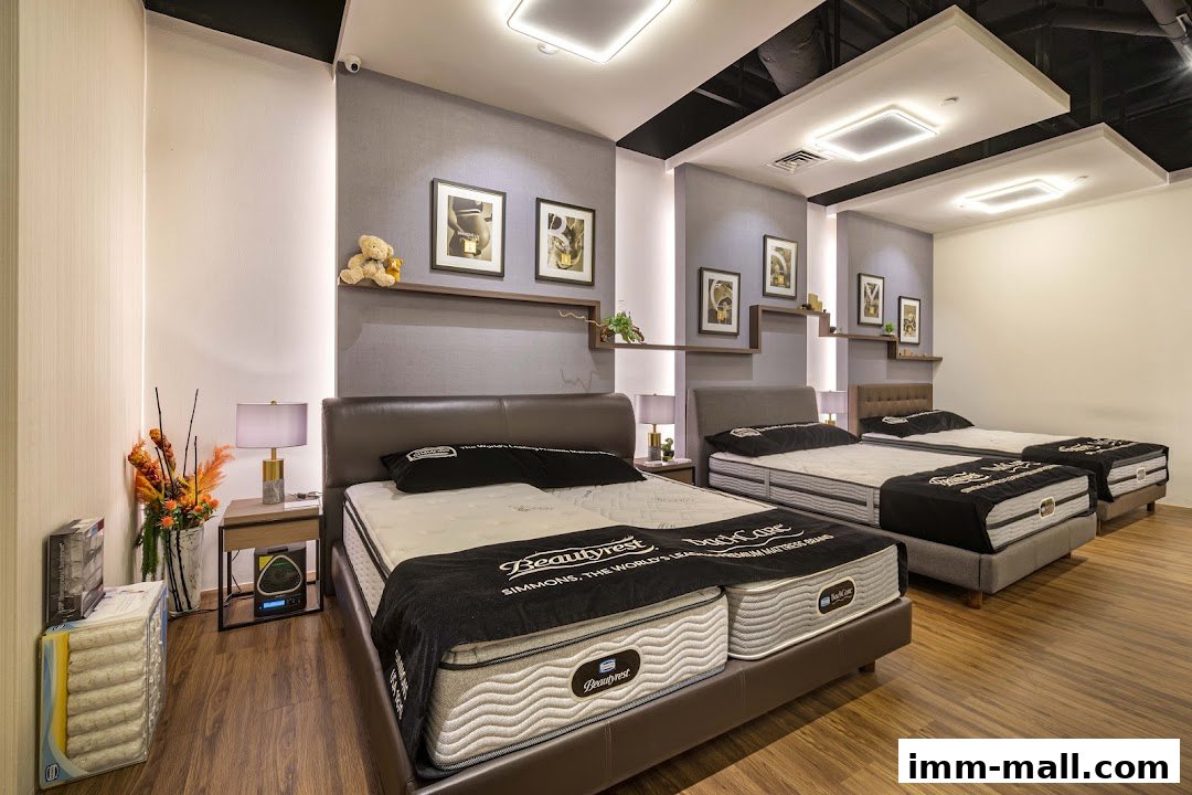 A showroom displaying multiple Simmons Beautyrest mattresses with elegant headboards and bedside lamps.