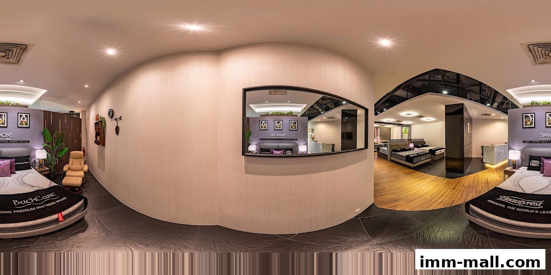 Interior view of a Simmons Gallery mattress store showcasing various beds and a reception area.