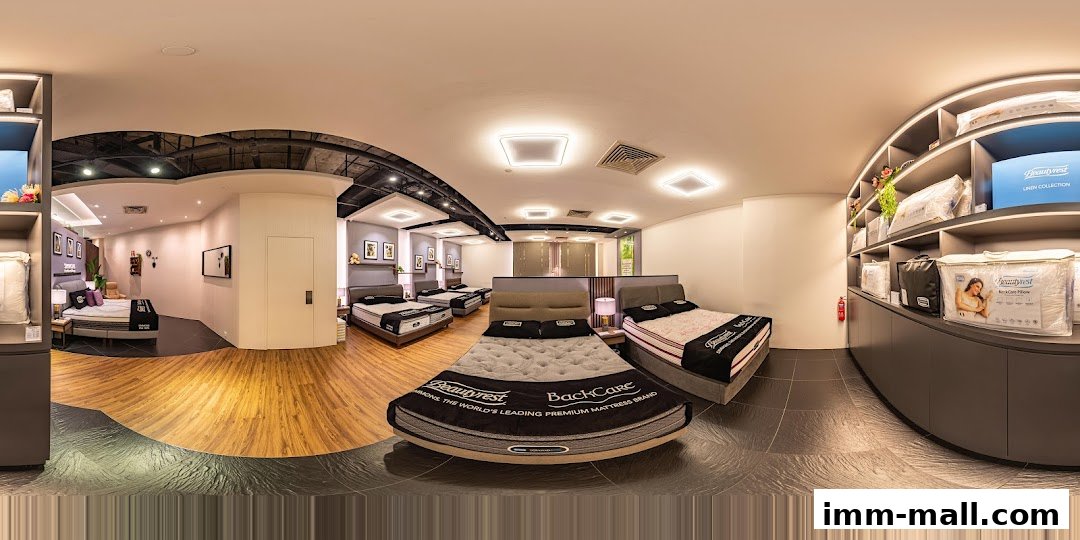 Interior view of a Simmons Gallery mattress showroom with multiple beds on display.