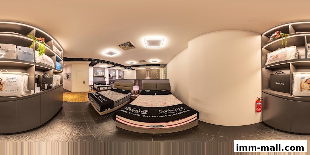 Interior view of a Simmons Gallery mattress store showcasing various beds and bedding products.