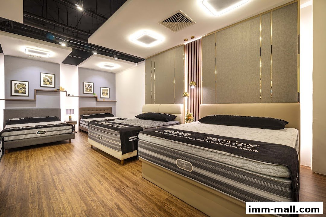 A showroom displaying multiple Simmons brand mattresses with elegant headboards and modern lighting.