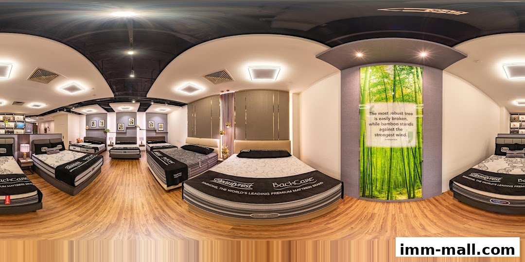 Interior view of a Simmons Gallery mattress store showcasing various beds and a motivational quote.