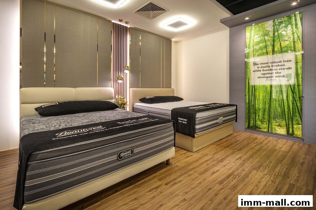Two Simmons Beautyrest mattresses displayed in a modern showroom with a bamboo forest graphic.
