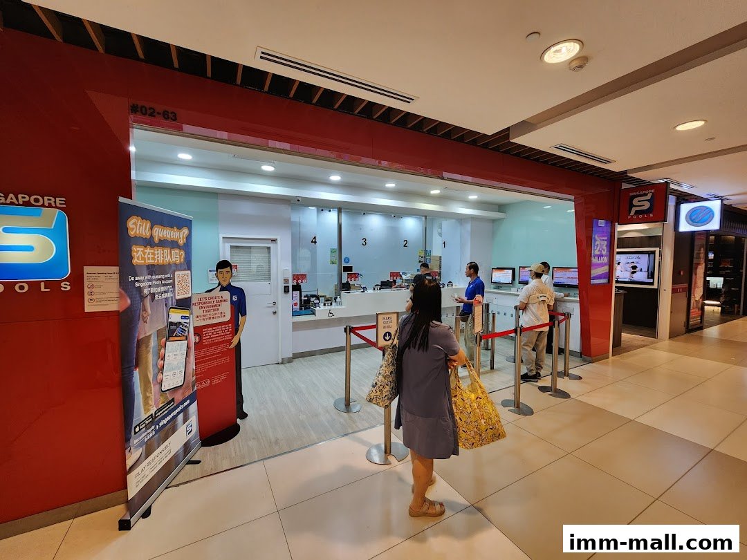 People at the counter of a Singapore Pools shop with promotional banners.