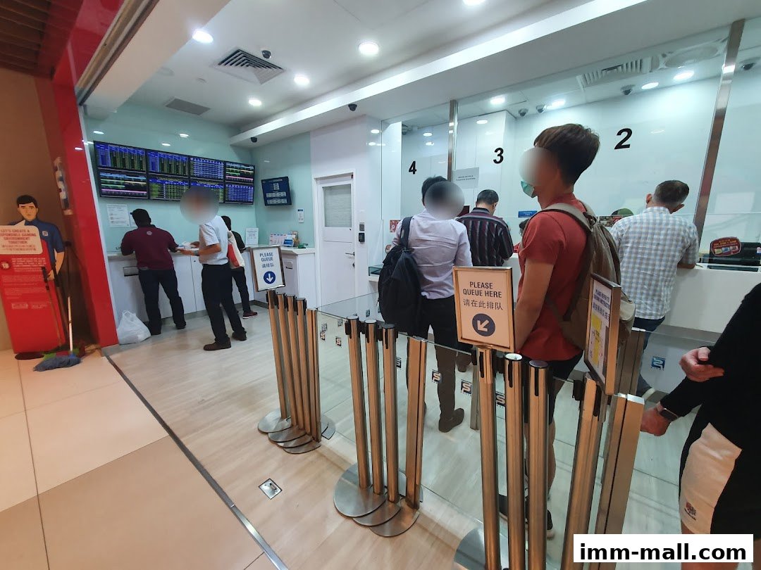 People queuing at Singapore Pools counters with screens displaying information.
