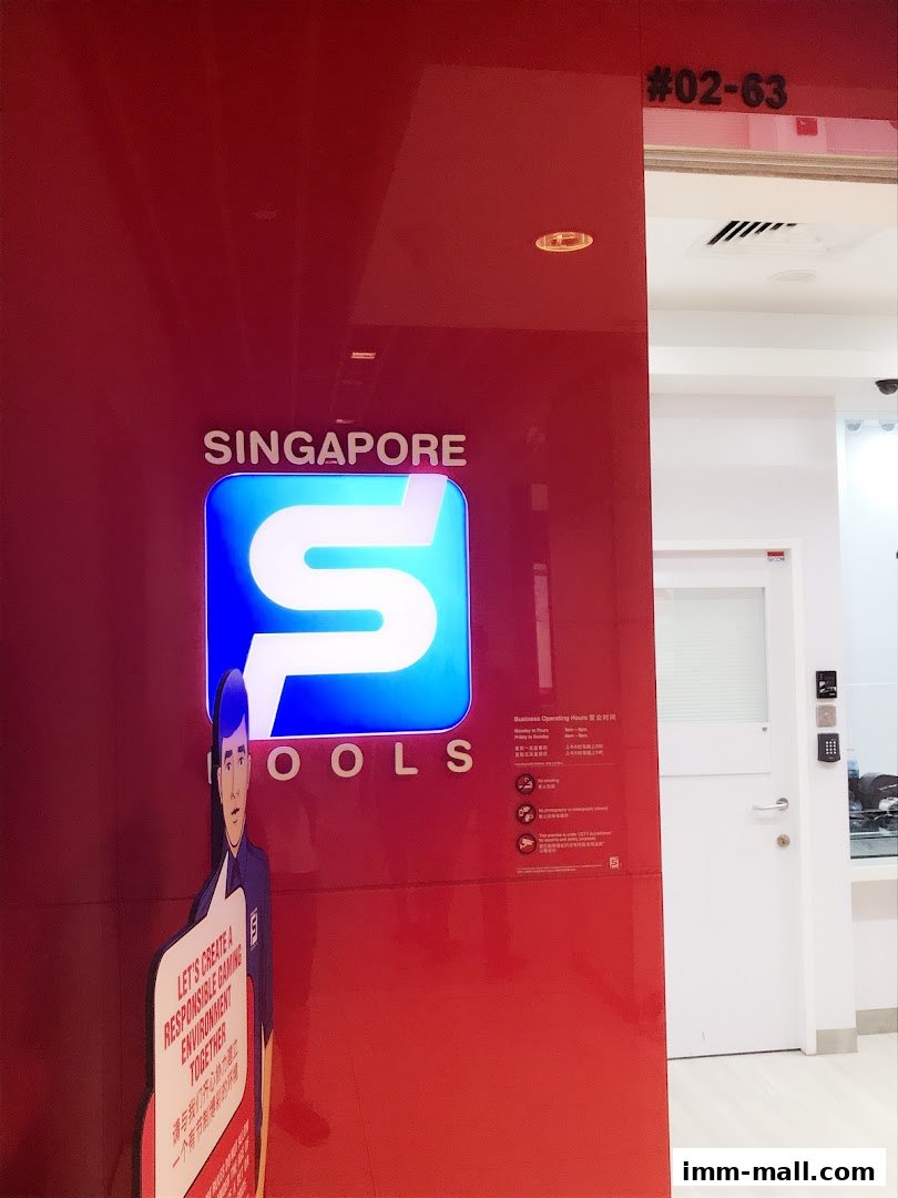 The Singapore Pools shop front with its prominent logo and a cutout promoting responsible gaming.