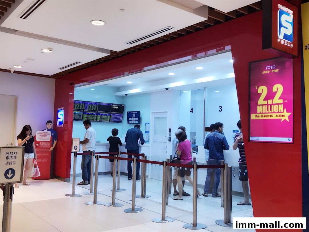 People queuing at the Singapore Pools counter with a large advertisement for a $2.2 million prize.