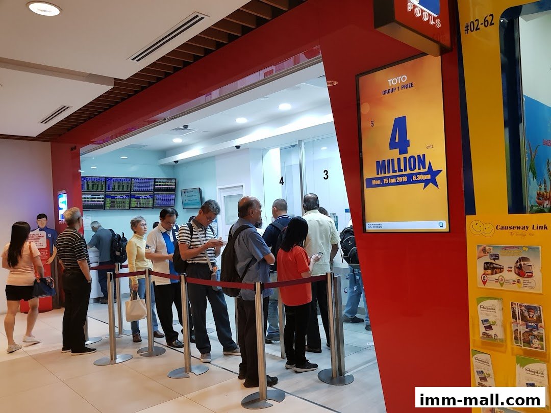 People queuing at Singapore Pools for a lottery draw with a large prize advertised.
