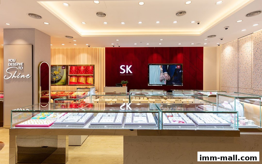 Interior view of a modern jewelry store with display cases filled with necklaces and rings.