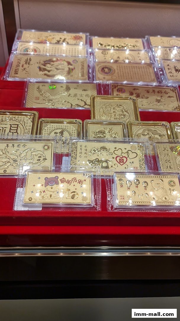 A display of various gold foil cards with intricate designs and auspicious symbols.