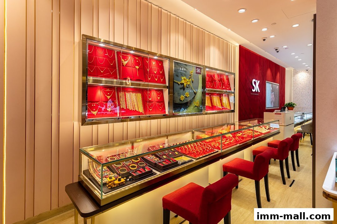 Interior of a jewelry store with display cases filled with gold necklaces, bracelets, and earrings.