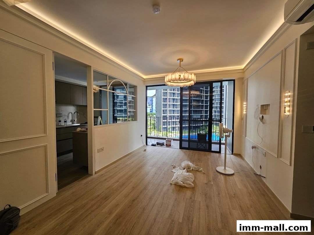 Interior view of a modern apartment with a kitchen visible through a partition and a balcony overlooking a city view.