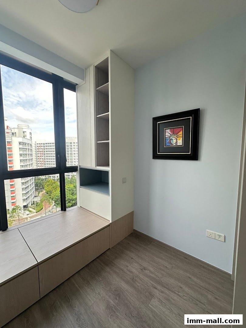 A bright room with a built-in window seat, shelves, and a framed artwork on the wall.