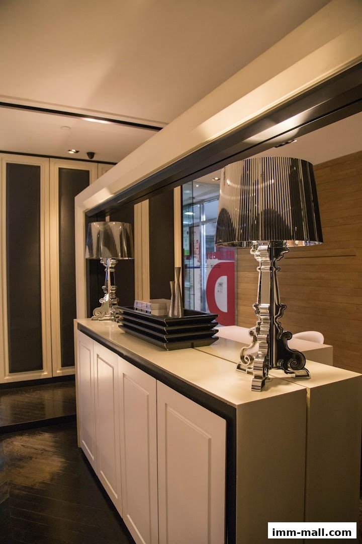 Interior shot of a shop with decorative lamps and cabinets, showcasing elegant design.