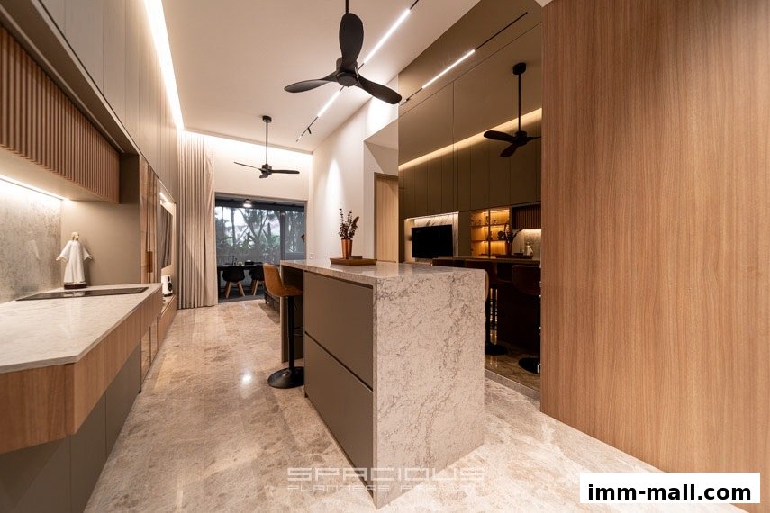 A modern kitchen and dining area with a marble island, sleek cabinetry, and ceiling fans.
