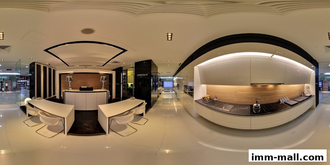 Interior view of a modern kitchen showroom with sleek cabinets and a display counter.