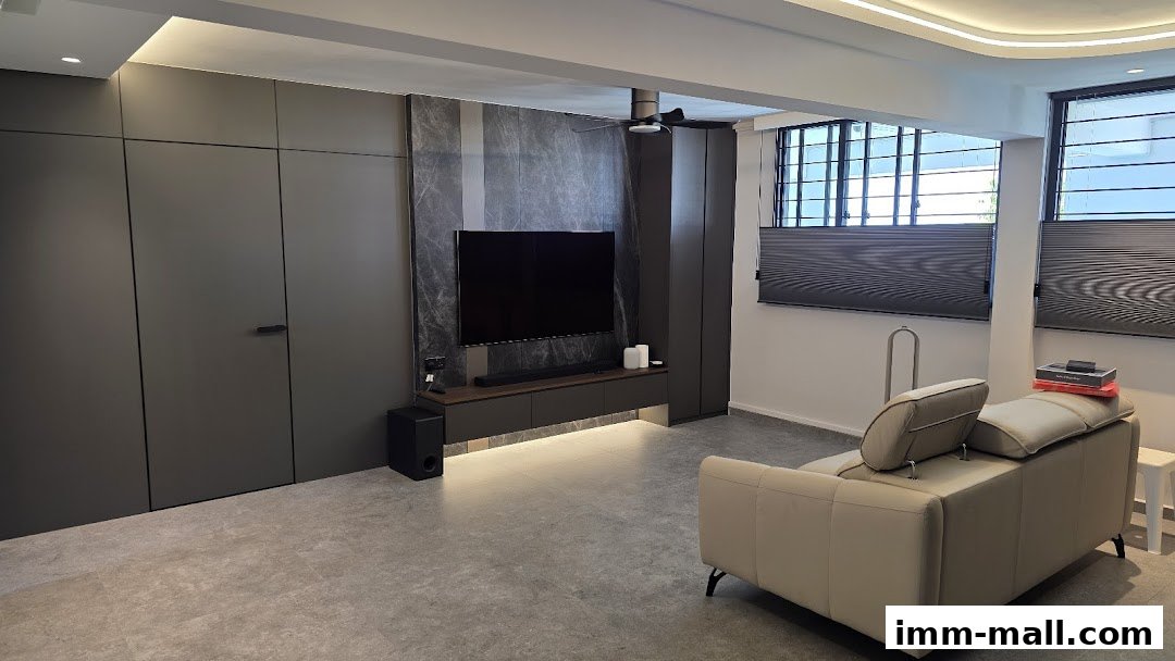 A modern living room with a large TV, sleek cabinetry, and a comfortable sofa.