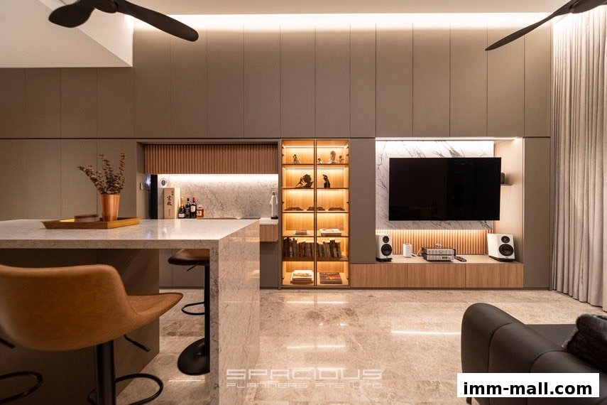 A modern living room with a marble island, built-in cabinets, and a large television.