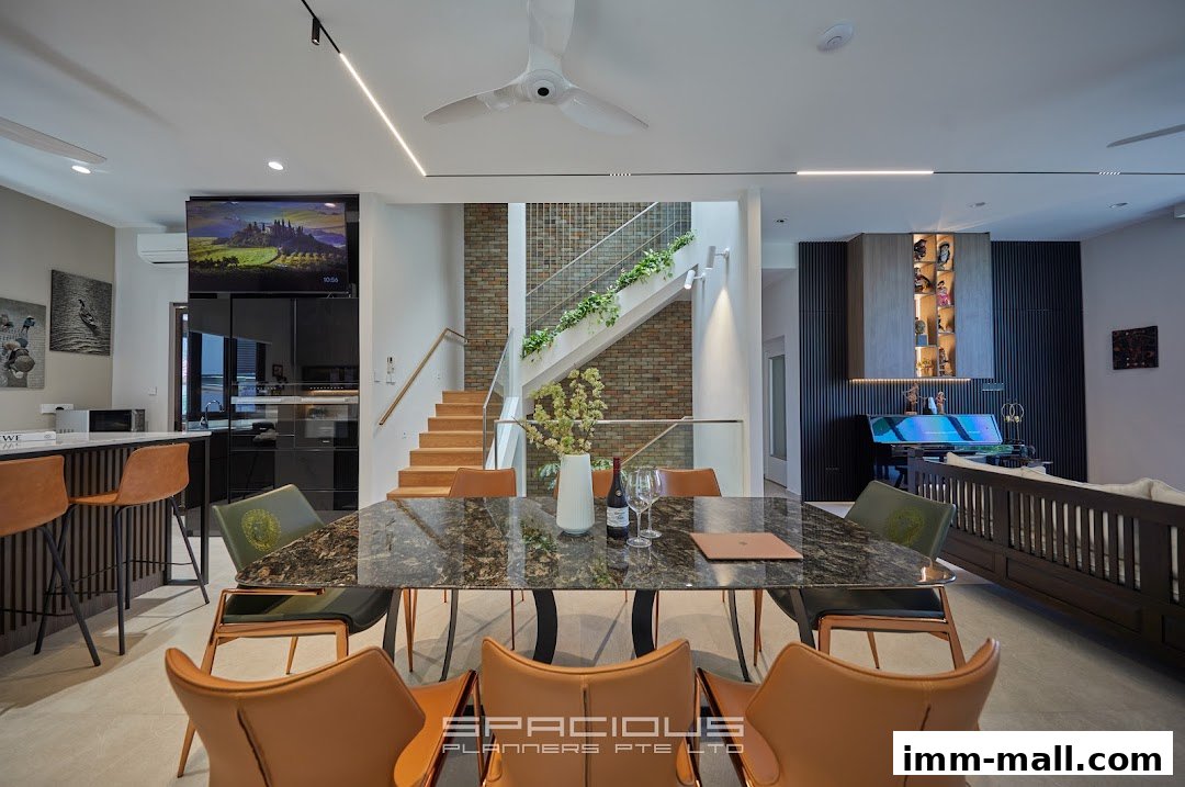 A modern dining and living area with a sleek dining table, stylish chairs, and a contemporary staircase.