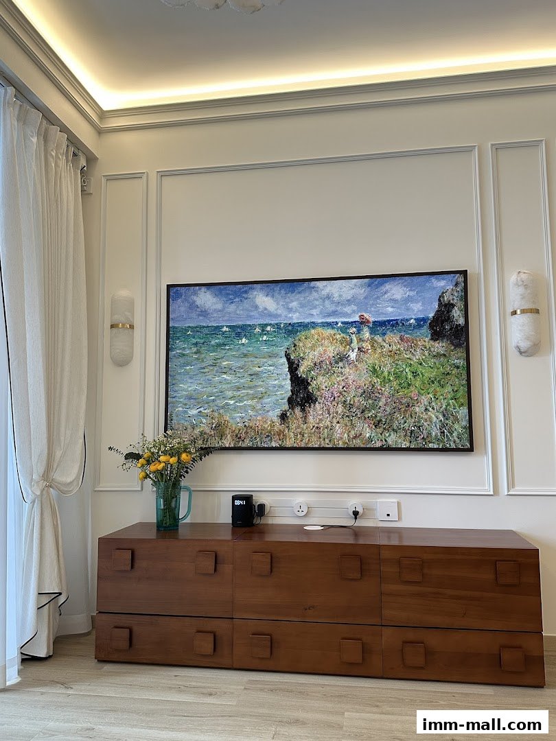 A modern living room featuring a large landscape painting above a wooden cabinet.