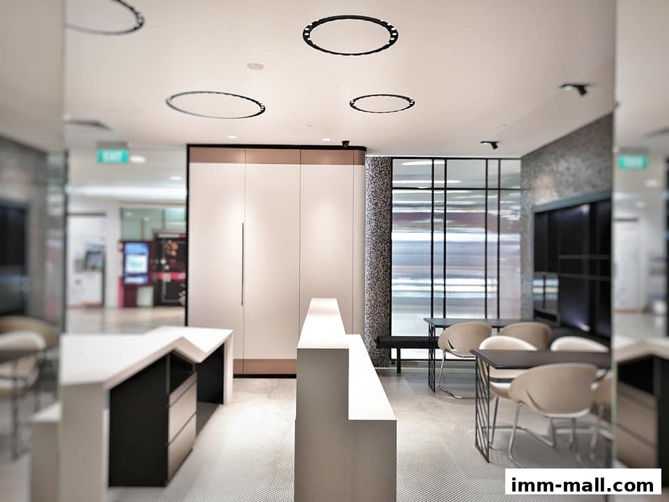 Interior view of a modern office or reception area with minimalist furniture and stylish lighting.