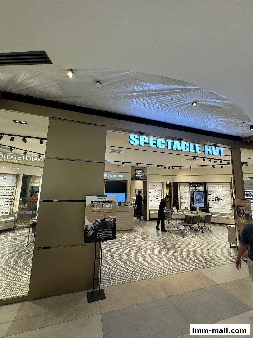 The exterior of Spectacle Hut, an eyewear store, showcasing various brands and a promotional sign.