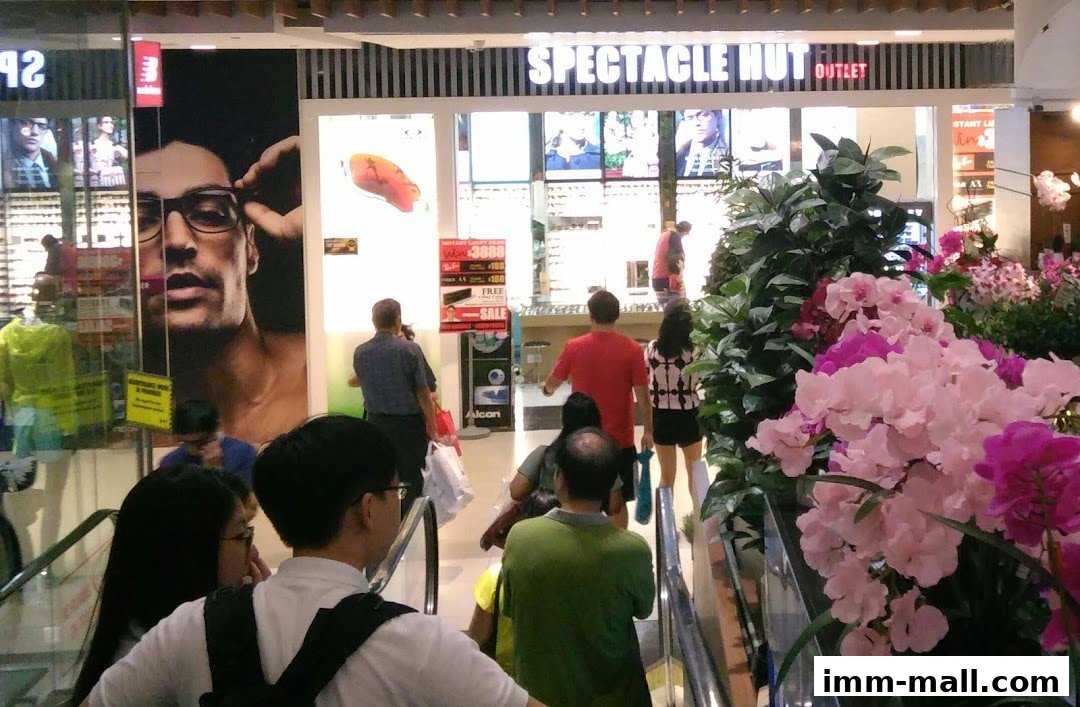 Spectacle Hut Outlet shop front with a large advertisement of a man wearing glasses.