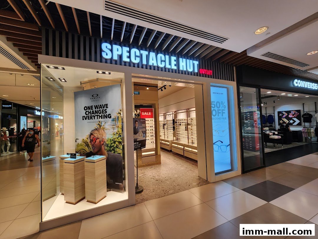 The exterior of Spectacle Hut, an eyewear store, with a promotional display and a sale sign.