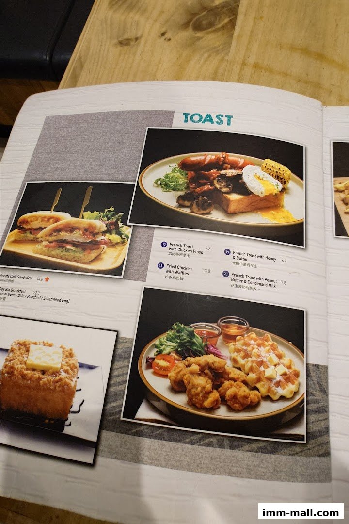 A menu page from Streats IMM featuring various toast and breakfast items with appealing food photography.