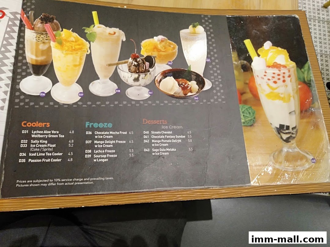 A menu from Streats IMM featuring various coolers, freezes, and desserts with prices.