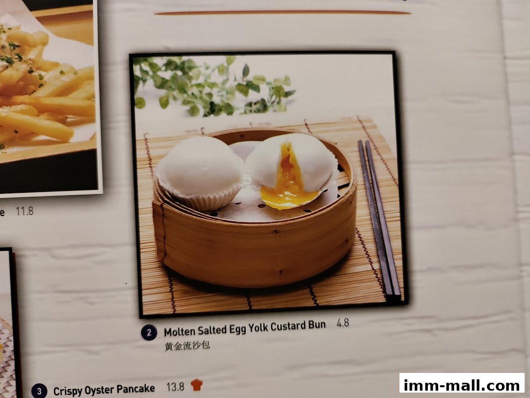 A close-up of a menu item featuring molten salted egg yolk custard buns.