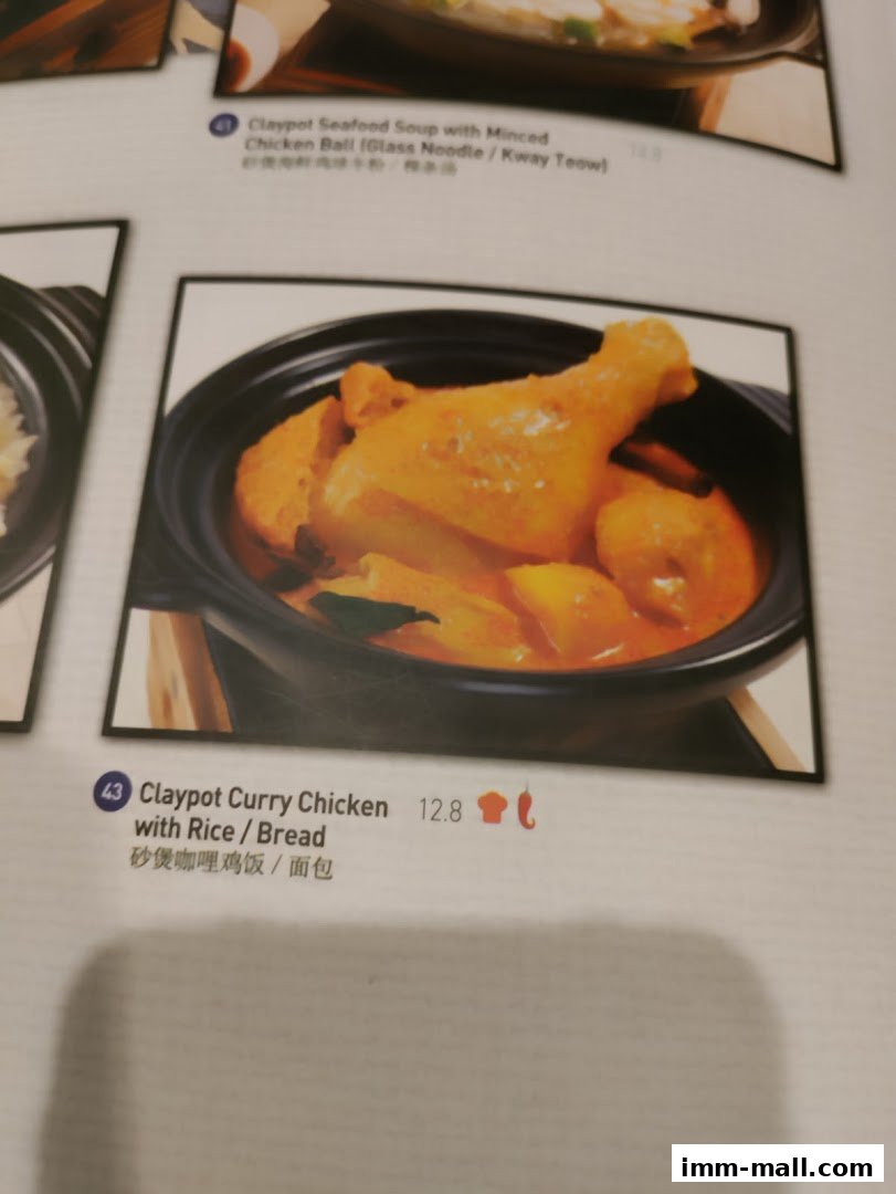 A menu item featuring Claypot Curry Chicken with Rice or Bread.