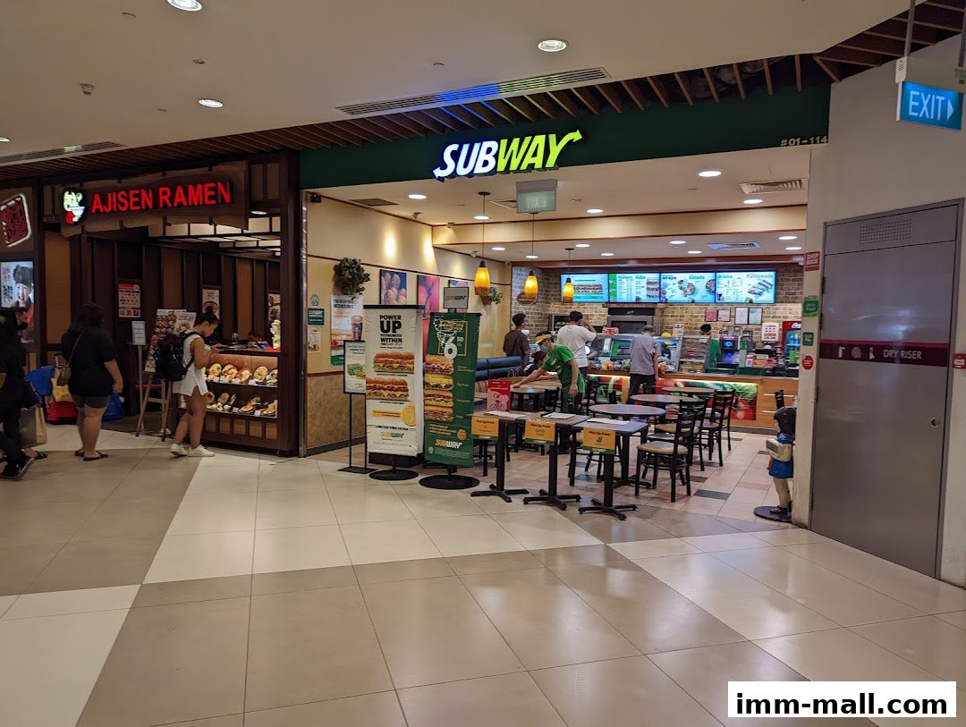 Subway restaurant interior with customers ordering and dining, next to Ajisen Ramen.