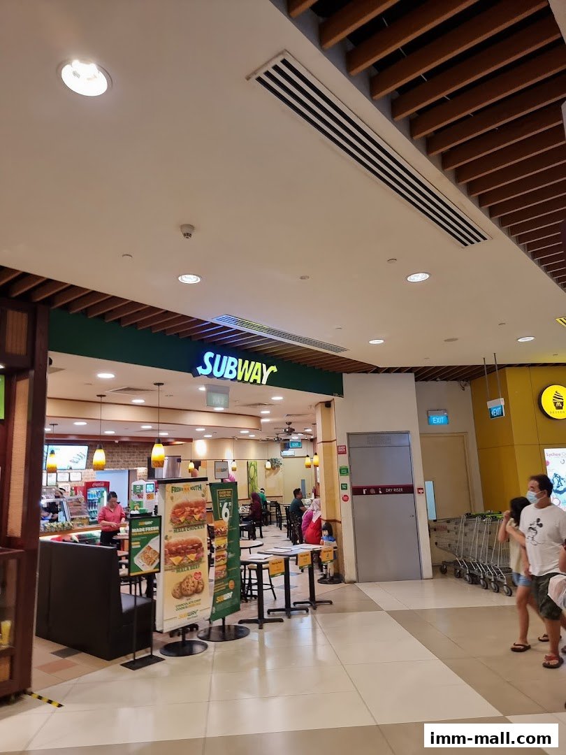 The entrance and interior of a Subway restaurant with customers and staff visible.