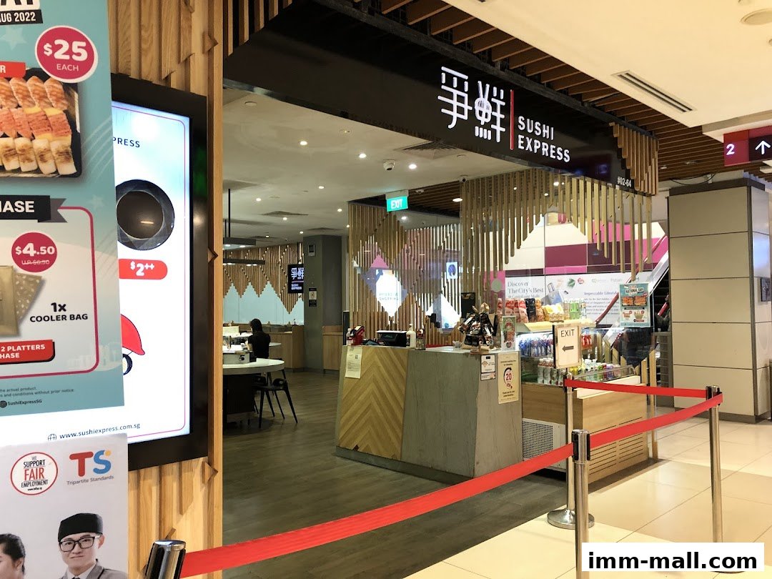 The entrance of Sushi Express at IMM mall, with promotional displays and a queue barrier.