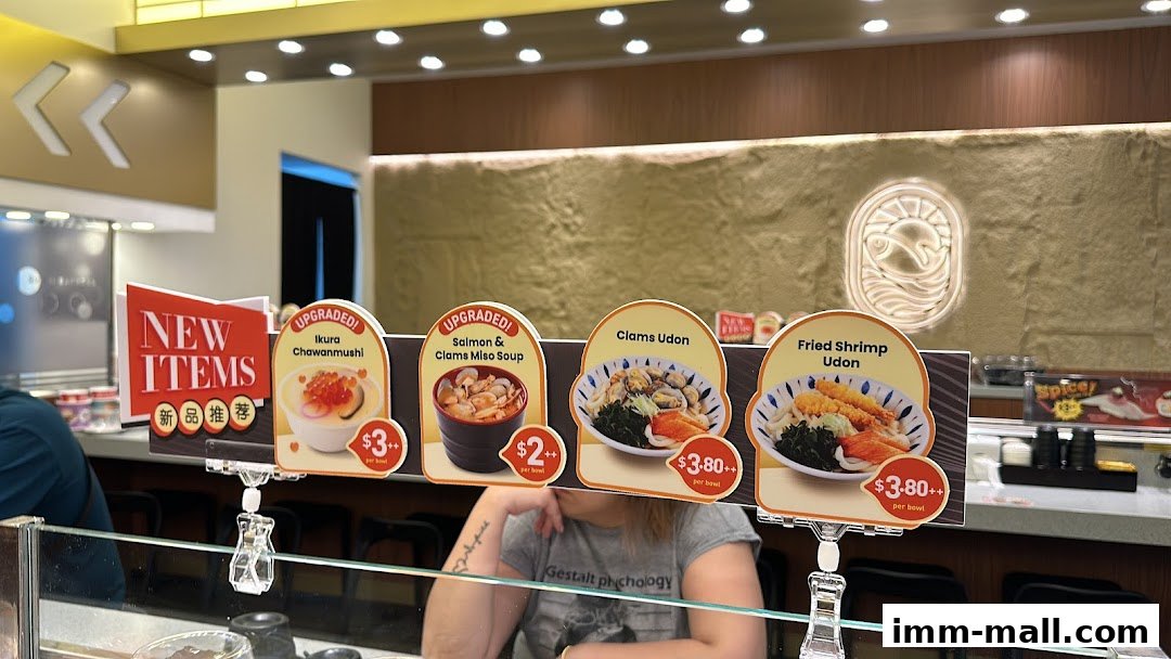 A display of new Japanese food items including udon and chawanmushi with prices.