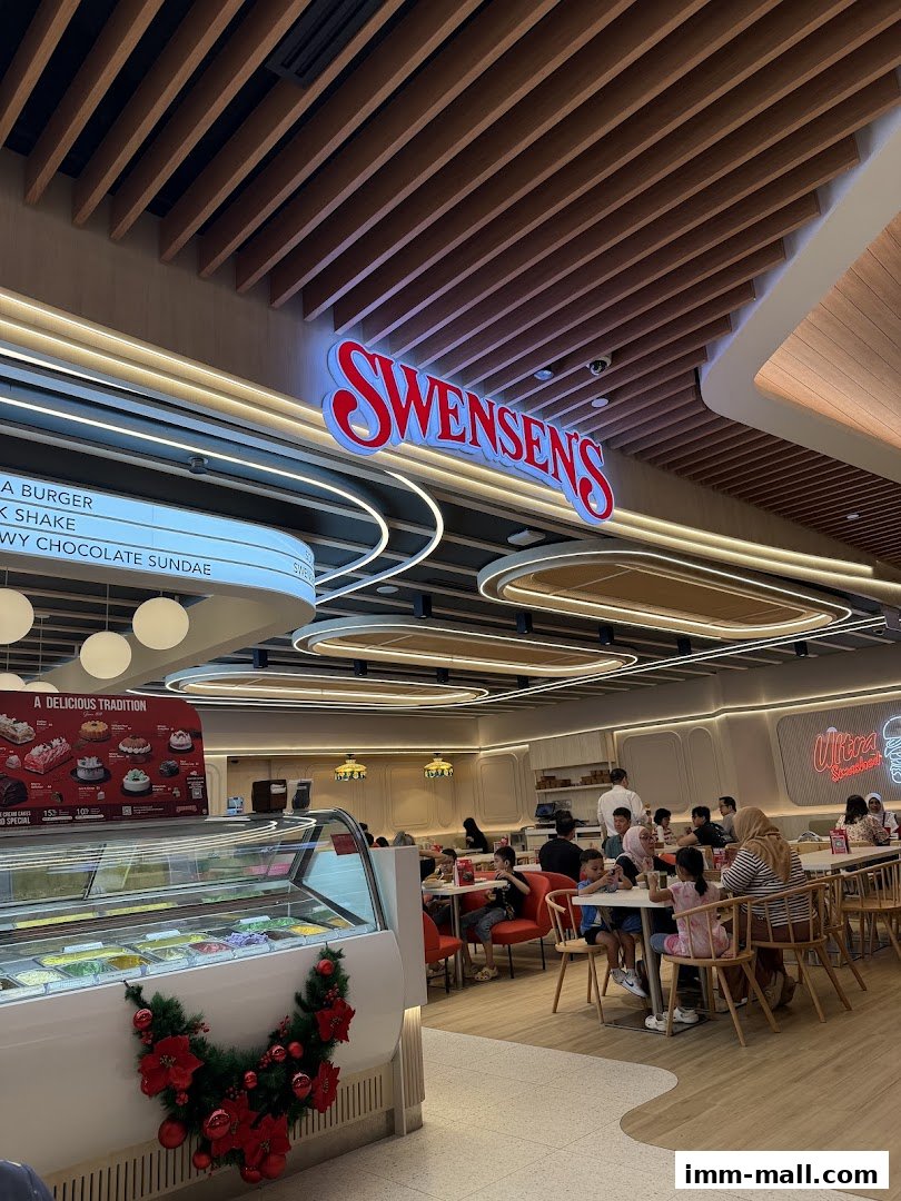 Interior of Swensens IMM with customers dining and an ice cream display.
