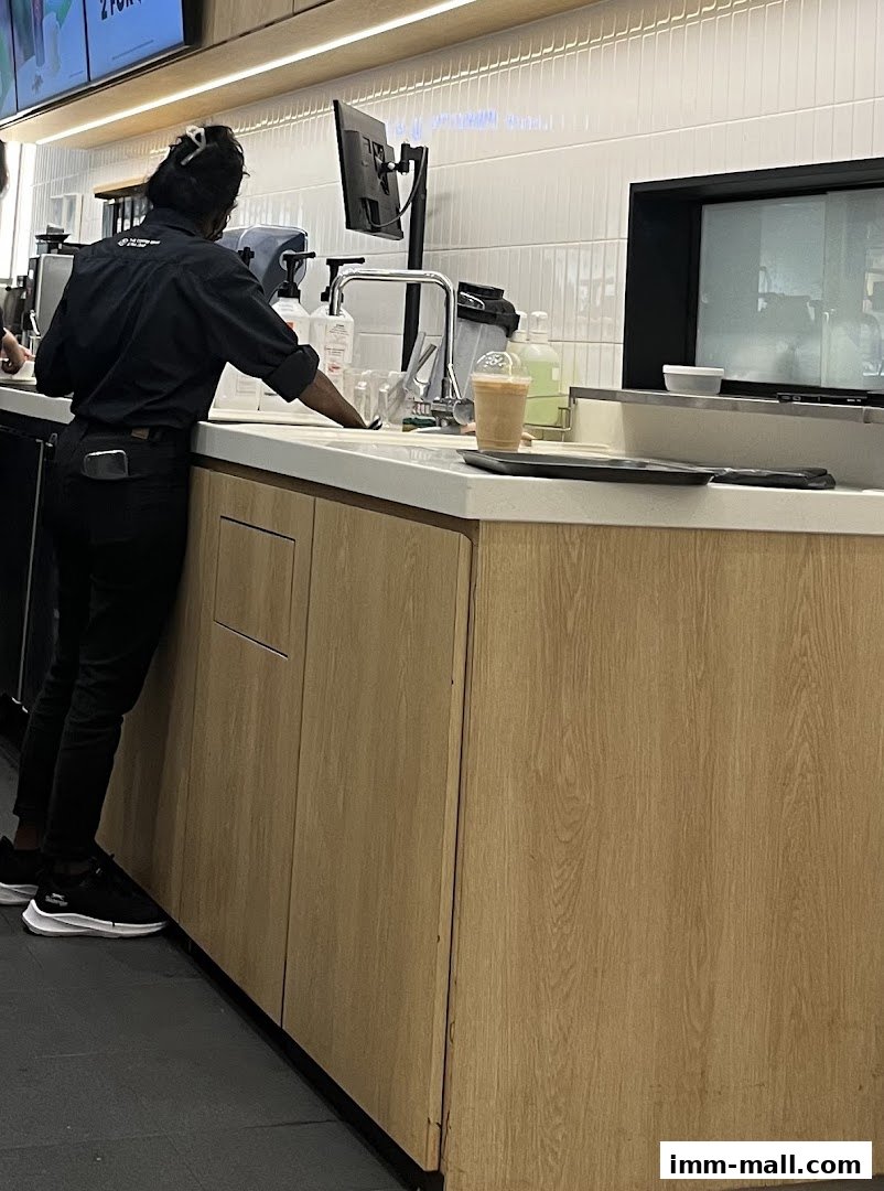 A barista prepares a drink behind the counter at The Coffee Bean & Tea Leaf.