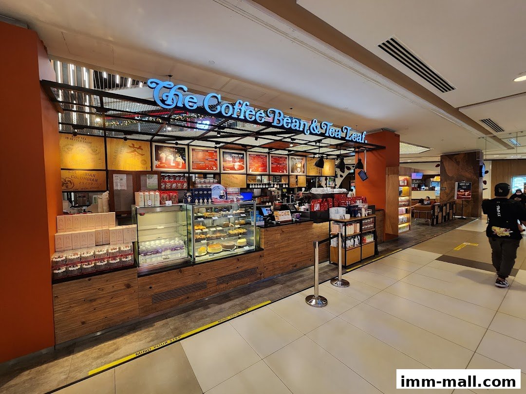 The Coffee Bean & Tea Leaf shop front with display cases of pastries and drinks.