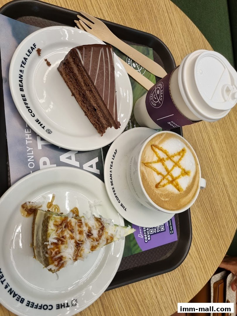 A tray with two slices of cake and a cup of coffee from The Coffee Bean & Tea Leaf.