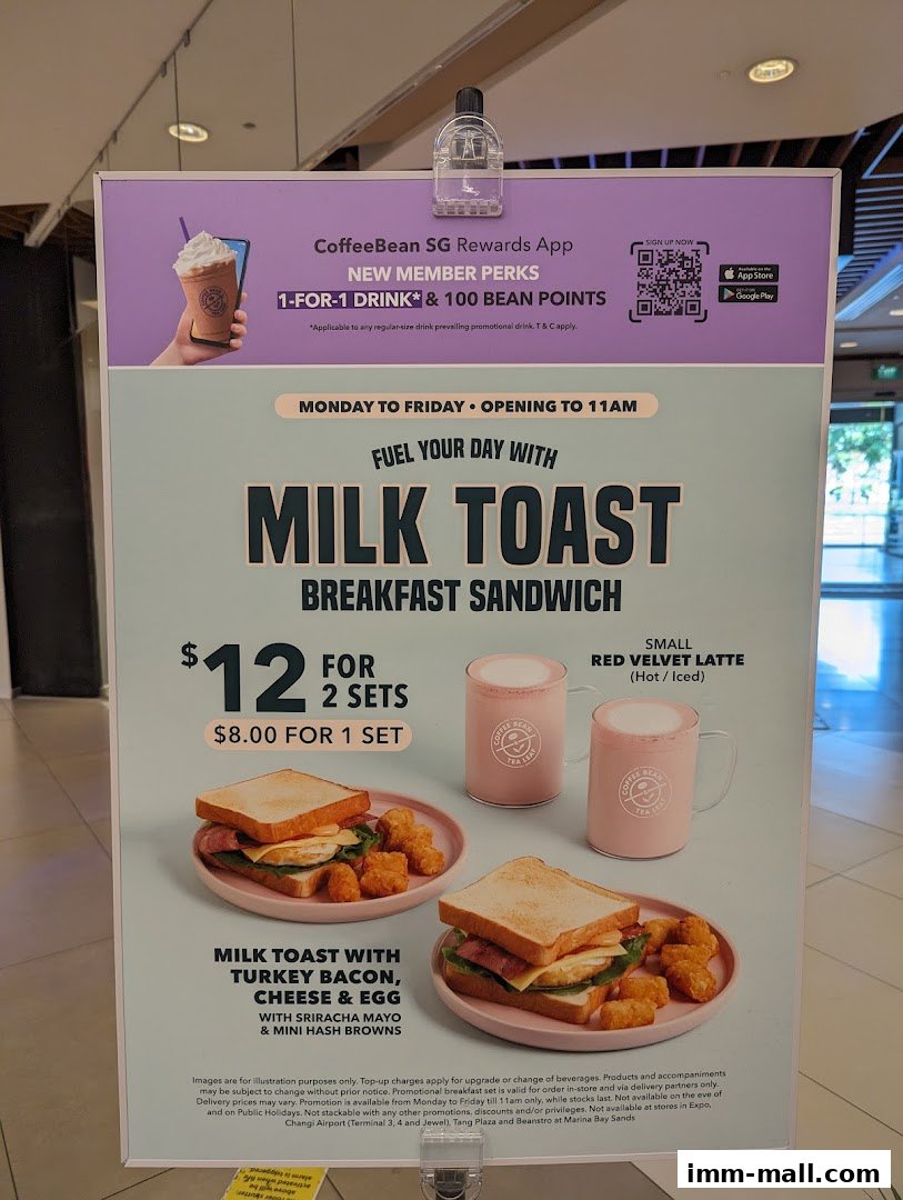A promotional sign for The Coffee Bean & Tea Leaf featuring breakfast sandwiches and lattes.