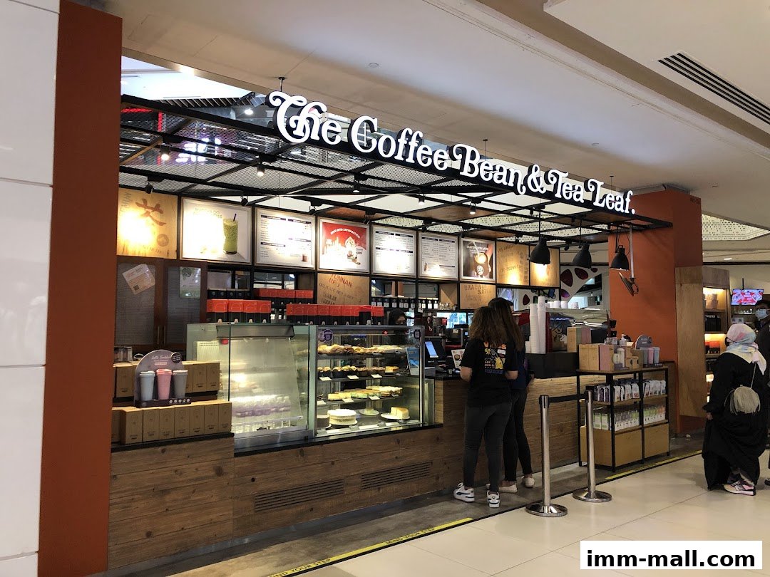 The Coffee Bean & Tea Leaf shop with customers ordering at the counter and display of pastries.