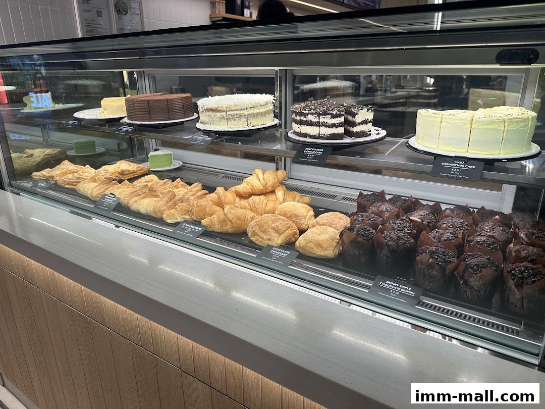 A display case filled with various pastries, cakes, and muffins at The Coffee Bean & Tea Leaf.