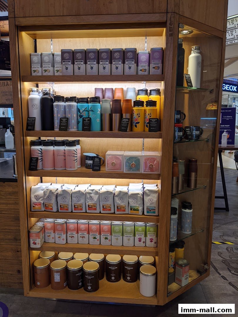A display cabinet filled with various coffee beans, teas, and drinkware from The Coffee Bean & Tea Leaf.