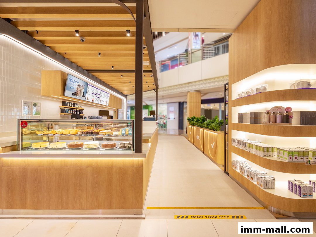 Interior view of The Coffee Bean Tea Leaf shop with a display of cakes and beverages.