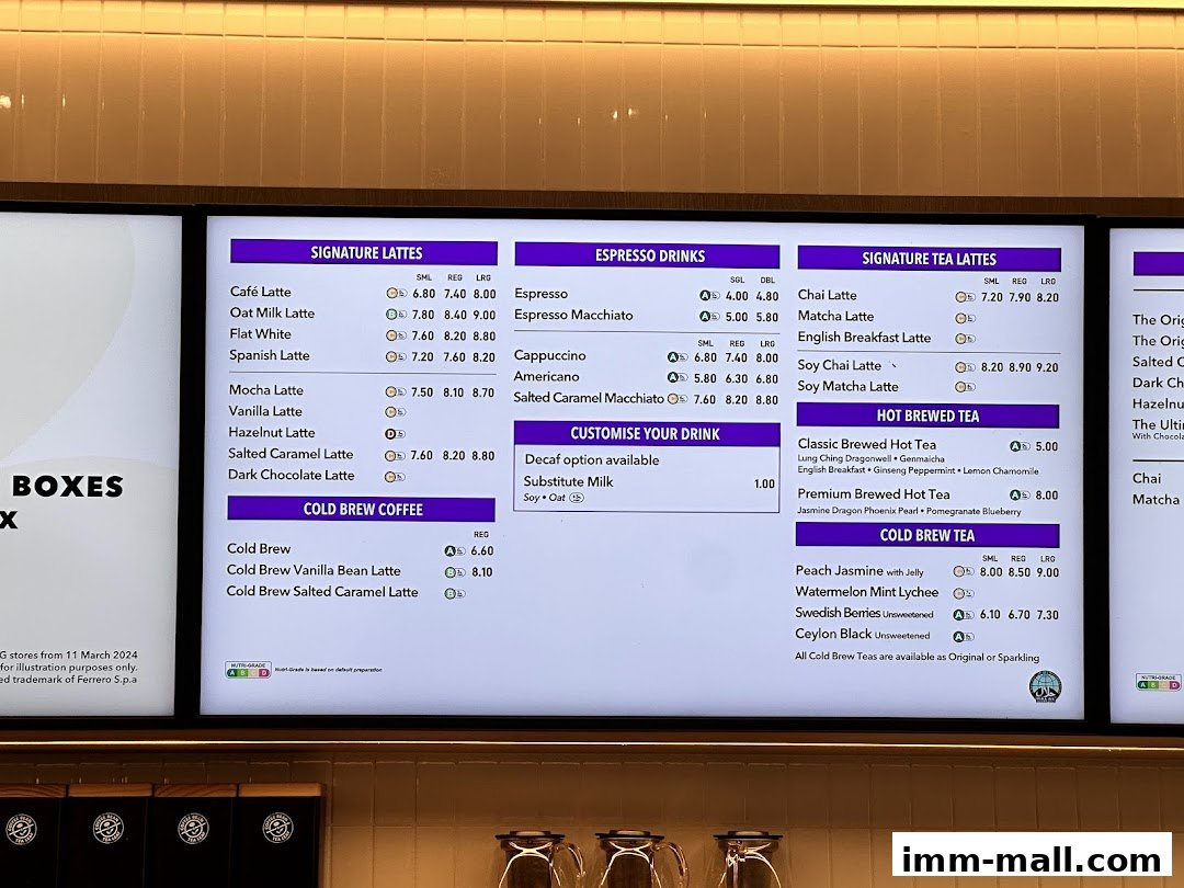 A digital menu board displaying various coffee and tea drinks with prices.