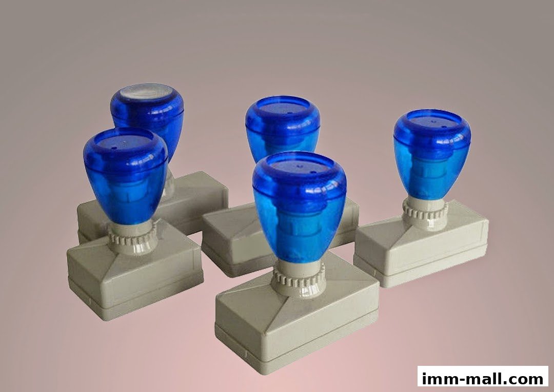 A group of blue and white self-inking stamps arranged on a plain background.