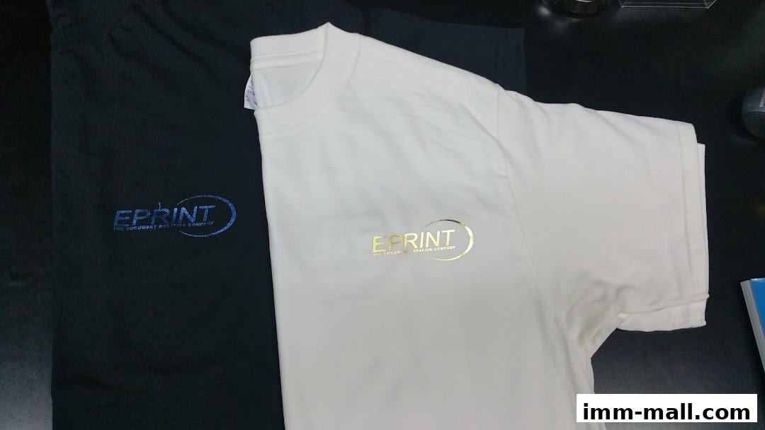 Two t-shirts, one black and one white, with the company logo printed on them.